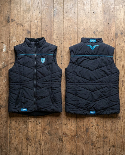 Black quilted vest with brand logo on a wooden surface